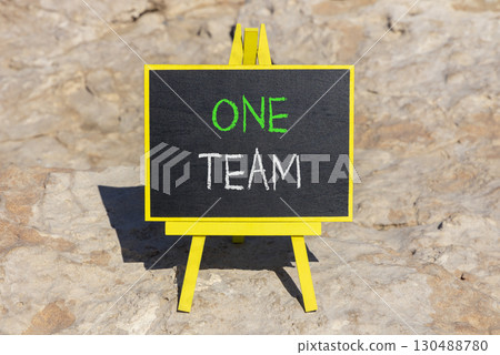 One team symbol. Concept word One team on beautiful black blackboard. Beautiful stone background. Black blackboard. Business one team concept. Copy space. One team symbol. Concept word One team on beautiful black blackboard. Beautiful stone background. Black blackboard. Business one team concept. Copy space. 130488780