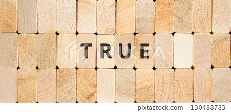 True symbol. Concept word True on beautiful wooden blocks. Beautiful wooden blocks background. Business, lifestyle, support and true concept. Copy space. True symbol. Concept word True on beautiful wooden blocks. Beautiful wooden blocks background. Business, lifestyle, support and true concept. Copy space. 130488783