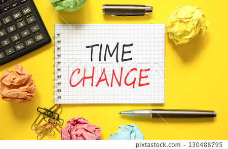 Time change symbol. Concept word Time change on beautiful white note. Black calculator. Black pen. Beautiful yellow paper background. Business time change concept. Copy space. 130488795
