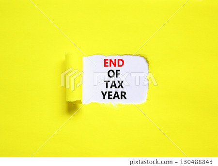 End of tax year symbol. Concept words phrase End of tax year on beautiful white paper. Beautiful yellow paper background. Business motivational End of tax year concept. Copy space. 130488843