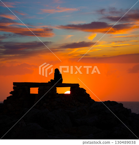 Ciutadella Menorca at Punta Nati sunset with girl Ciutadella Menorca at Punta Nati sunset with girl 130489038