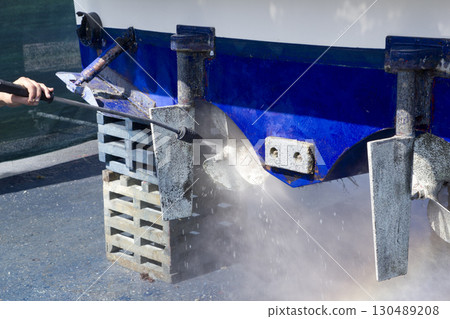 blue boat hull cleaning pressure washer barnacles 130489208