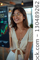 Woman looking at a stock chart 130489262