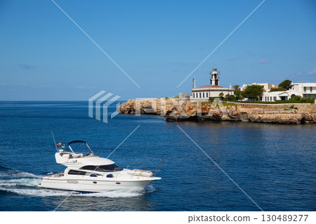 Ciutadella Sa Farola Lighthouse with yatch boat Ciutadella Sa Farola Lighthouse with yatch boat 130489277