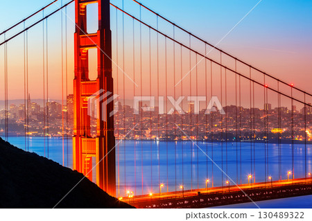 San Francisco Golden Gate Bridge sunrise through cables 130489322