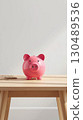 Pig piggy bank in the room 130489536