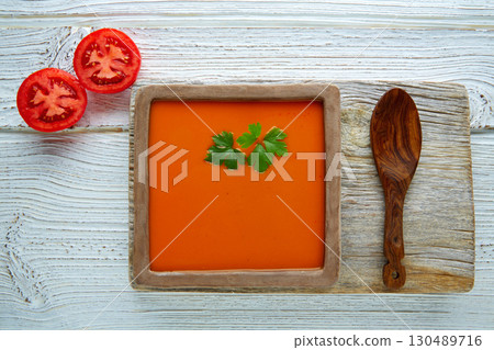 Tomato sauce on square dish and white wood 130489716