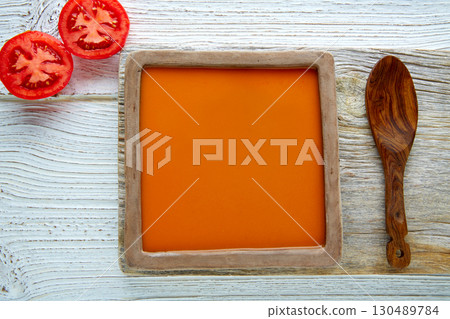 Tomato sauce on square dish and white wood 130489784