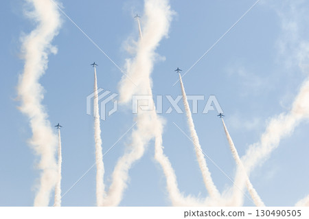 An aircraft flying while leaving a contrail An aircraft flying while leaving a contrail 130490505