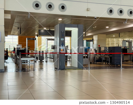 Airport security checkpoint with scanning machines and gates. Safety, regulation and travel control in modern transportation systems. Airport security checkpoint with scanning machines and gates. Safety, regulation and travel control in modern transportation systems. 130490514