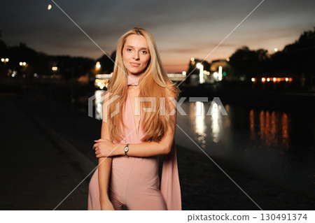 Elegant evening stroll by the river with captivating twilight colors 130491374