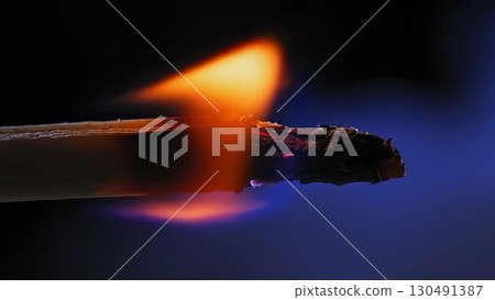Wooden stick burning, transitioning from solid to fiery orange blue flames, emitting smoke against dark backdrop during gradual combustion process Wooden stick burning, transitioning from solid to fiery orange blue flames, emitting smoke against dark backdrop during gradual combustion process 130491387