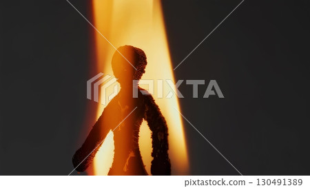 Fragile human figurine burning fiercely, conveying raw social conflict, personal destruction, vulnerability against menacing dark backdrop expressing intense emotional turmoil Fragile human figurine burning fiercely, conveying raw social conflict, personal destruction, vulnerability against menacing dark backdrop expressing intense emotional turmoil 130491389