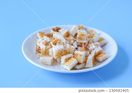 Crispy dry Cubed bread toasted bread on color background. 130491405