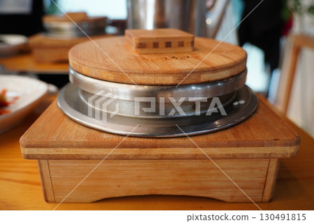 Steaming Korean Rice Pot on Wooden Table Steaming Korean Rice Pot on Wooden Table 130491815