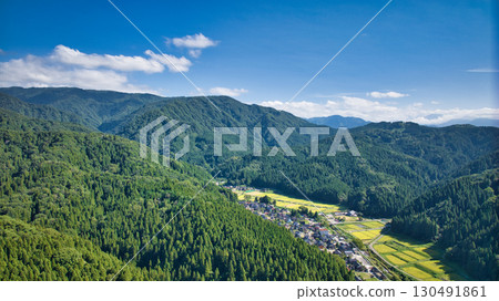 A view of the village and surrounding mountains in the Sasagawa district of Asahi Town in eastern Toyama Prefecture 130491861