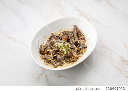 Gourmet beef tongue with creamy sauce, mushrooms and sprouts on marble background Gourmet beef tongue with creamy sauce, mushrooms and sprouts on marble background 130491933