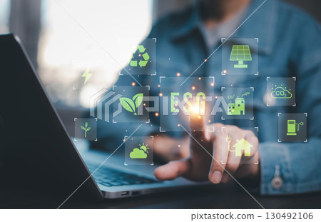 Man using computer and touching esg icon for environmental,social and governance concept. Man using computer and touching esg icon for environmental,social and governance concept. 130492106