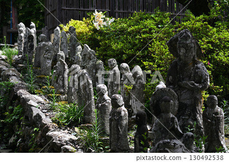 A row of small Jizo statues A row of small Jizo statues 130492538