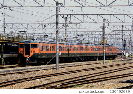 2007: Four 113 series electric trains undergoing inspection at a depot 130492689