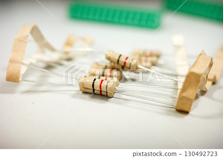 Electronic beige resistors with colored bands on neutral background Electronic beige resistors with colored bands on neutral background 130492723