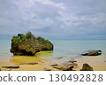 Subtropical sandy beaches and rocks, and a calm emerald sea under a cloudy sky 130492828