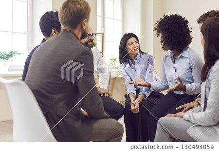 Group of business people sitting on chairs in a circle Group of business people sitting on chairs in a circle 130493059