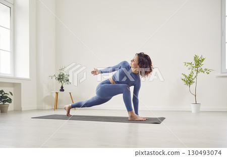 Yogi young sporty woman doing exercise, pose, working out indoor, firness student training at yoga Yogi young sporty woman doing exercise, pose, working out indoor, firness student training at yoga 130493074