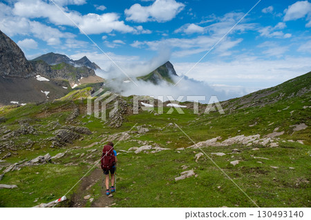 Sporty woman hiking in Switzerland alps. Heathy lifestyle, sport, beauty in nature. Grindelwald valley, Swizz Sporty woman hiking in Switzerland alps. Heathy lifestyle, sport, beauty in nature. Grindelwald valley, Swizz 130493140