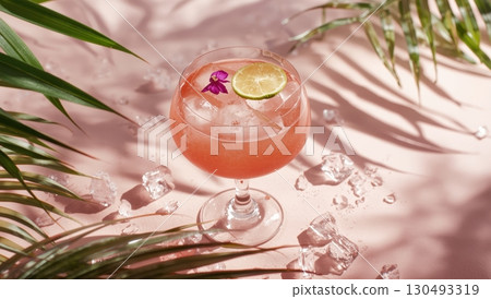 Light pink guava fizz in coupe glass with lime and flower Light pink guava fizz in coupe glass with lime and flower 130493319