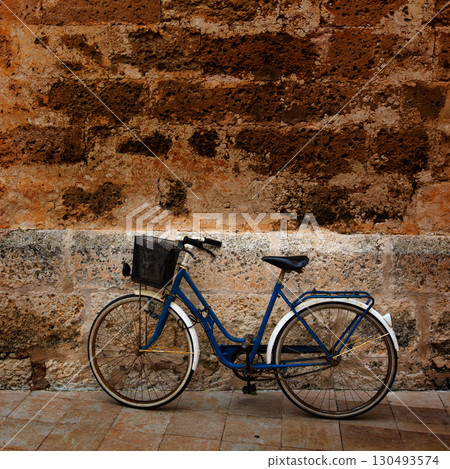 Bicycle in historical Ciutadella stone wall at Balearics 130493574