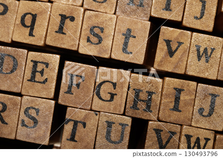Jumbled up block wood print letters lined up Jumbled up block wood print letters lined up 130493796