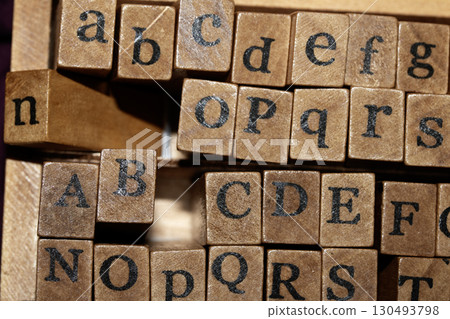 Jumbled up block wood print letters lined up Jumbled up block wood print letters lined up 130493798