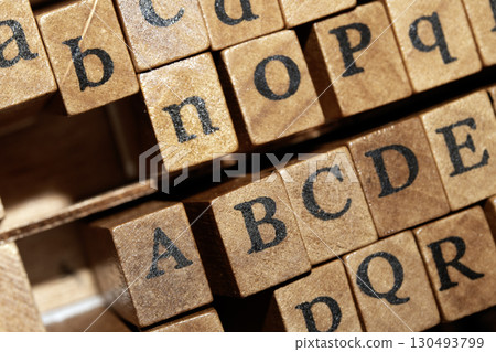 Jumbled up block wood print letters lined up 130493799