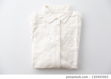 A yellowed and faded white vintage long-sleeved button-down shirt A yellowed and faded white vintage long-sleeved button-down shirt 130493983