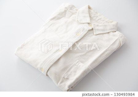 A yellowed and faded white vintage long-sleeved button-down shirt 130493984