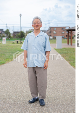 Senior man standing with a smile 130494059
