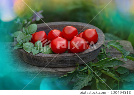 Red round tomatoes that have a thin tip. Pepper shaped tomatoes in a wooden bowl Red round tomatoes that have a thin tip. Pepper shaped tomatoes in a wooden bowl 130494518