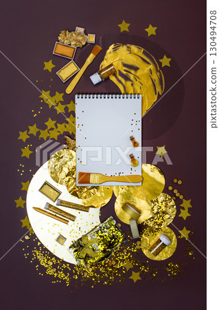Empty free copy space for your picture. Overhead view blank notebook pages mockup. Golden color supplies top view flat lay. Empty free copy space for your picture. Overhead view blank notebook pages mockup. Golden color supplies top view flat lay. 130494708