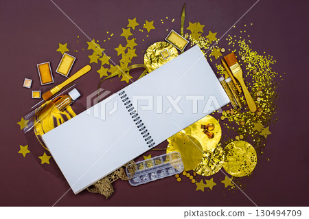 White notebook mockup for text on light backdrop. Golden stationery and materials for creativity top view. Golden art crafts White notebook mockup for text on light backdrop. Golden stationery and materials for creativity top view. Golden art crafts 130494709