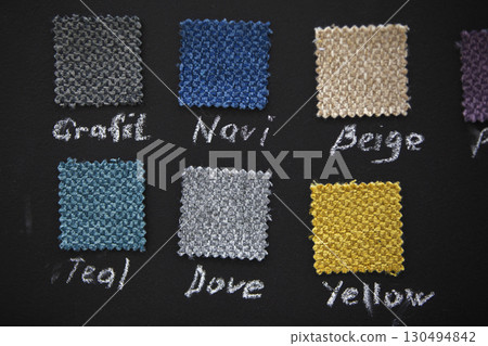 Samples of fabrics for sewing furniture on a dark background. 130494842