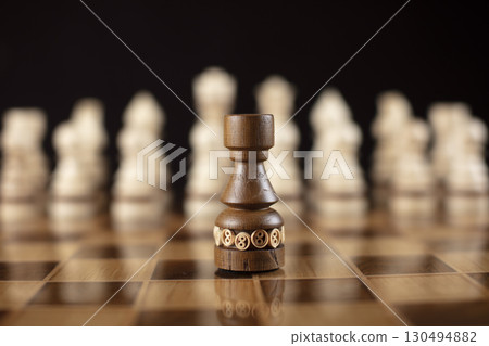 Chess on a dark background. A puzzle game with tricky combinations that requires planning and thinking. 130494882