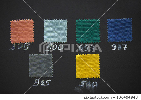 Samples of fabrics for sewing furniture on a dark background. 130494948