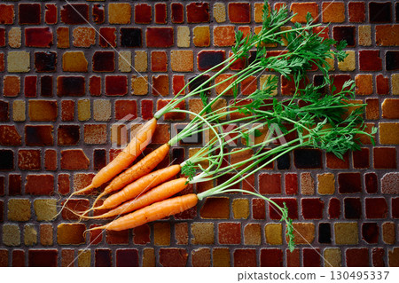 Mini Carrot vegetables on a tiles table 130495337