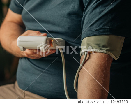 Middle-Aged Man Checking Blood Pressure at Home 130495593