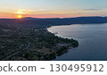 Breathtaking sunset over tranquil lake with serene hills in the background revealing nature's beauty and serenity 130495912