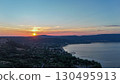 Sunset over serene lake and hills, capturing natural beauty in peaceful evening light 130495913