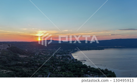 Sunset over serene lake and hills, capturing natural beauty in peaceful evening light Sunset over serene lake and hills, capturing natural beauty in peaceful evening light 130495913