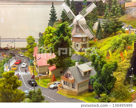 A miniature model shows suburban houses, cars, and people on streets with greenery. Architecture, community, and transportation represent urban lifestyle, culture, and everyday neighborhood life. A miniature model shows suburban houses, cars, and people on streets with greenery. Architecture, community, and transportation represent urban lifestyle, culture, and everyday neighborhood life. 130495995