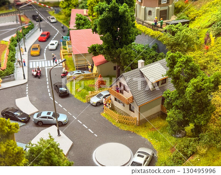 A miniature model shows suburban houses, cars, and people on streets with greenery. Architecture, community, and transportation represent urban lifestyle, culture, and everyday neighborhood life. A miniature model shows suburban houses, cars, and people on streets with greenery. Architecture, community, and transportation represent urban lifestyle, culture, and everyday neighborhood life. 130495996
